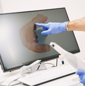 Pointing to image of teeth on monitor