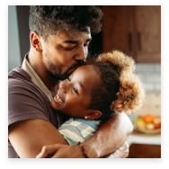 Father kissing daughter on the forehead