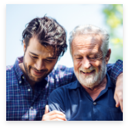 Two bearded man smiling outside