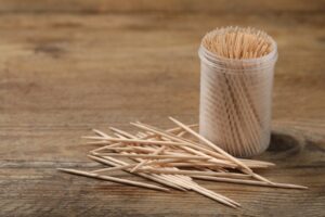 Table with a container full of toothpicks